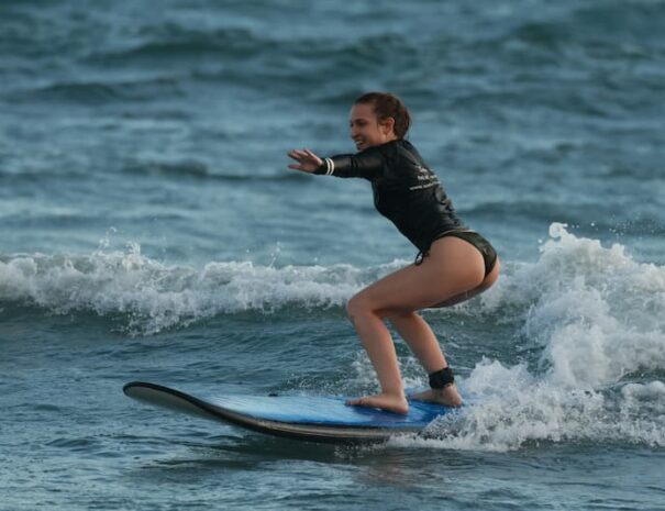 Beginner surfer taking a lesson at a Sepeda surf hostel in Canggu