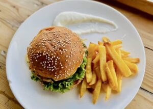 Juicy chicken or veggie burger with homemade french fries at Sepeda Hostel cafe in Canggu bali